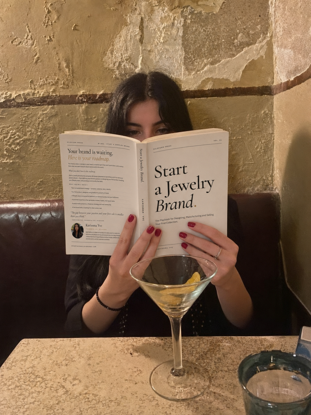 Reader enjoying Start A Jewelry Brand with a martini at a candlelit bar