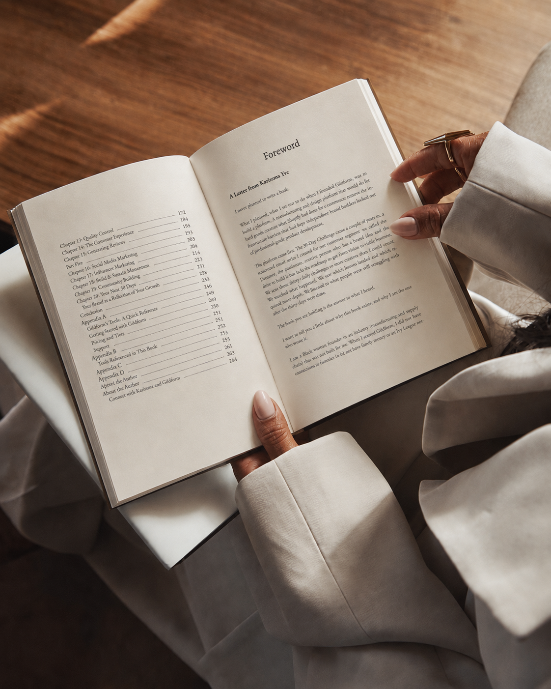 Reader holding Start A Jewelry Brand open to the Foreword in warm afternoon light